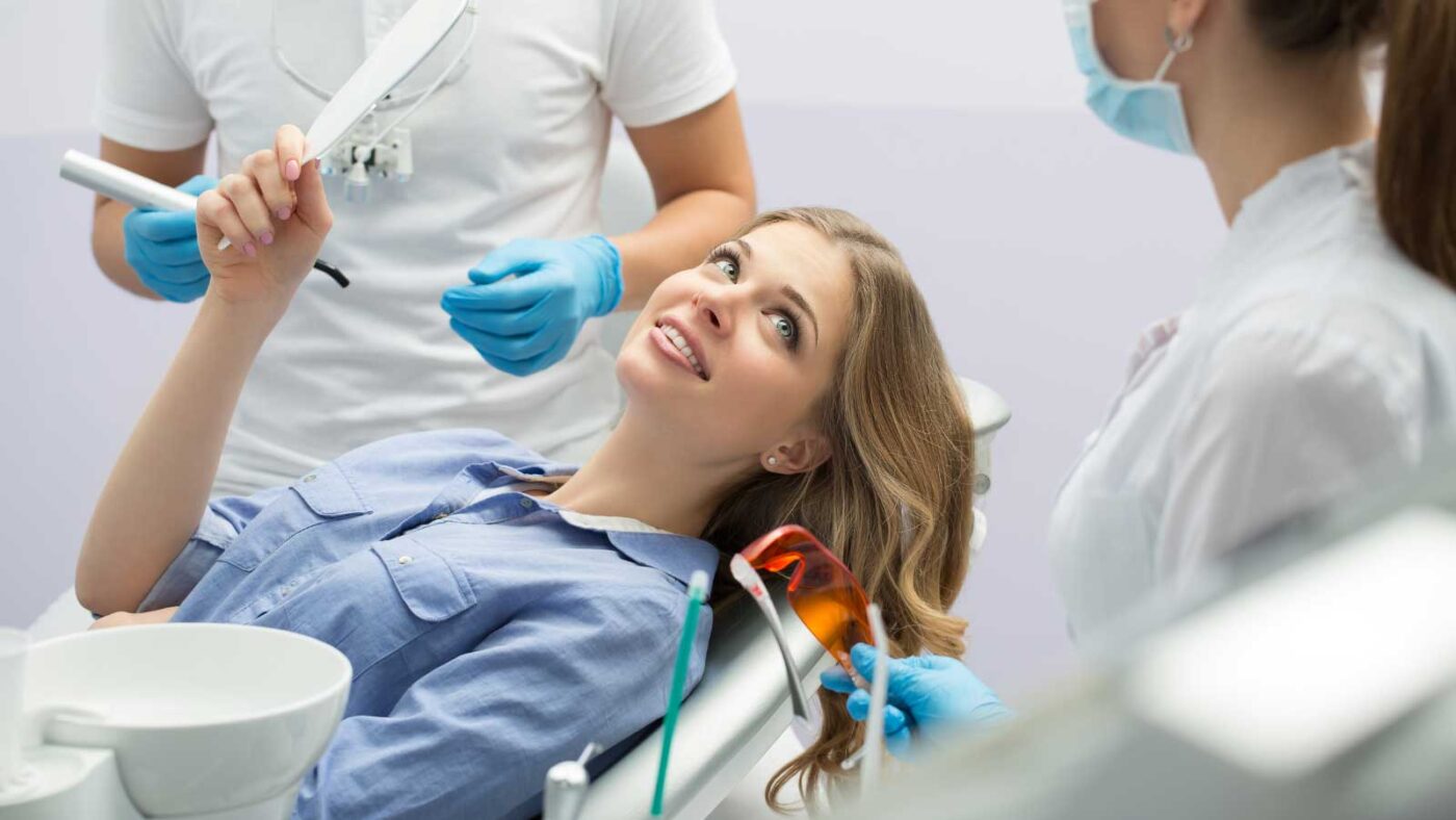 Smiling woman at a dental appointment.