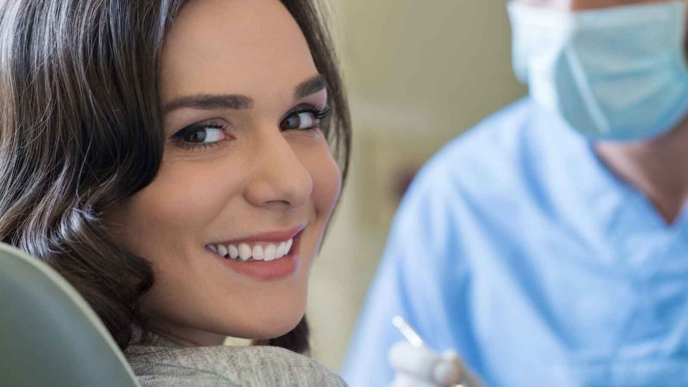  Smiling woman sitting in a dental chair during a checkup
