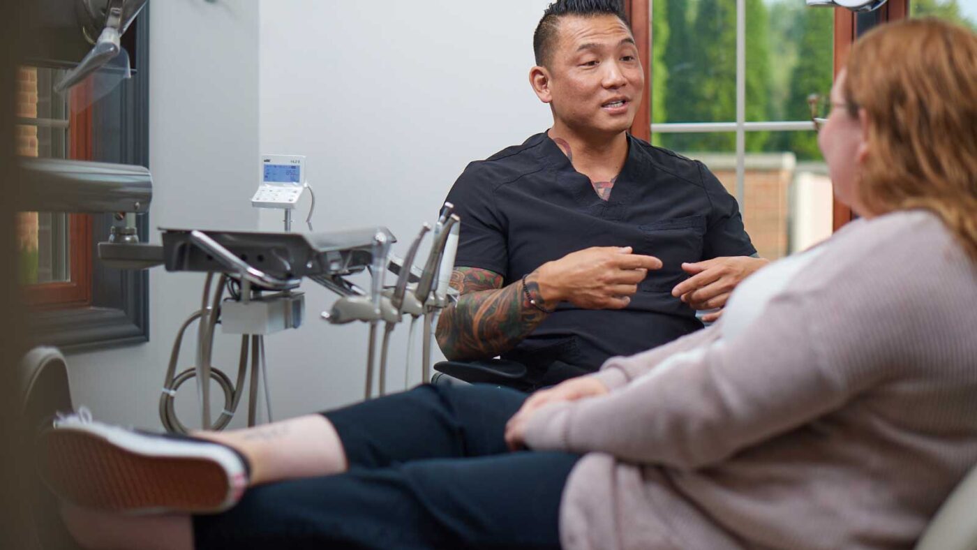 A dentist discussing treatment options with a patient in a relaxed setting