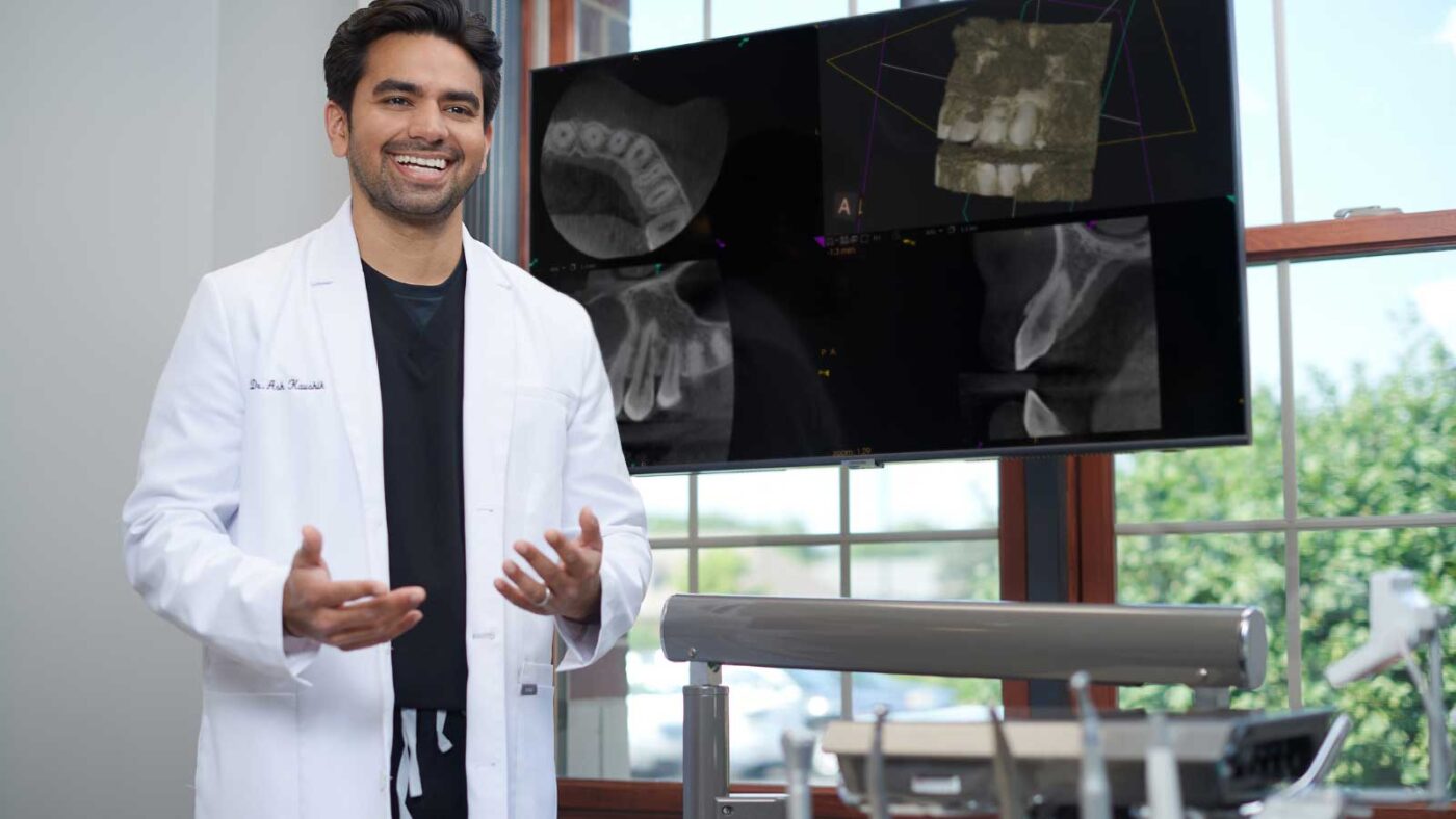 A dentist explaining dental imaging results in a modern clinic