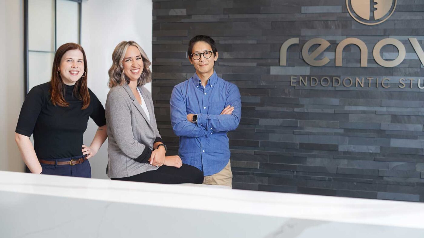 Renovo Endodontic Studio team members smiling at the reception area