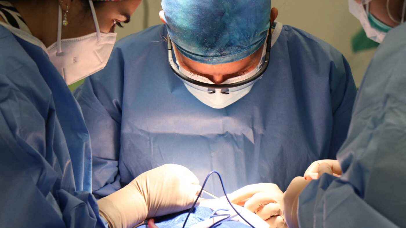 Surgeons performing a procedure in a sterile operating room