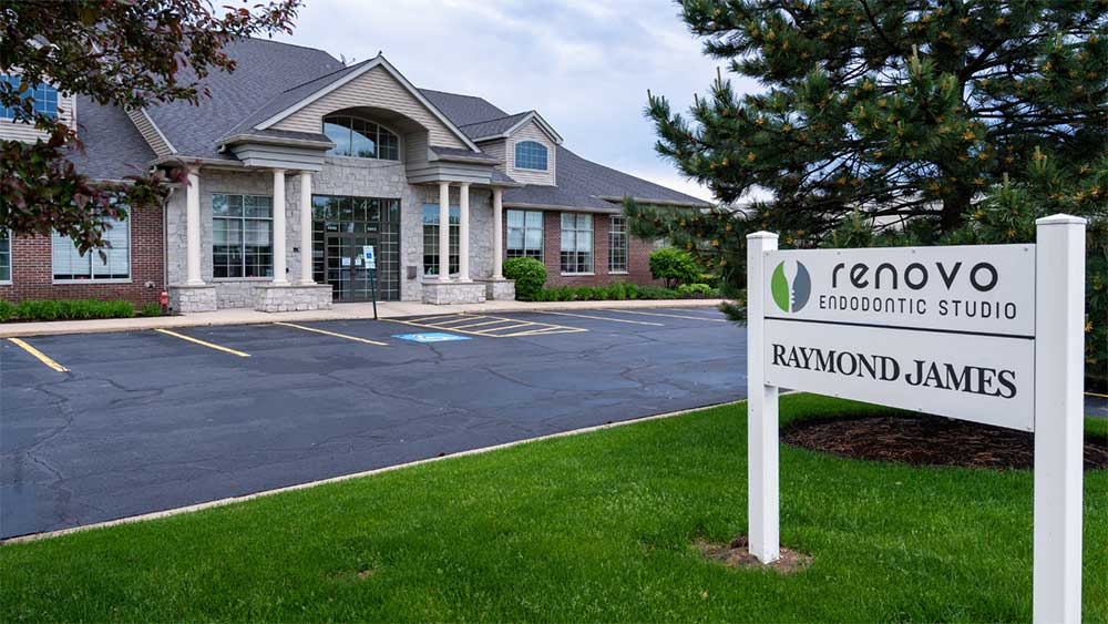 Exterior of Renovo Endodontic Studio with a visible sign and parking lot.