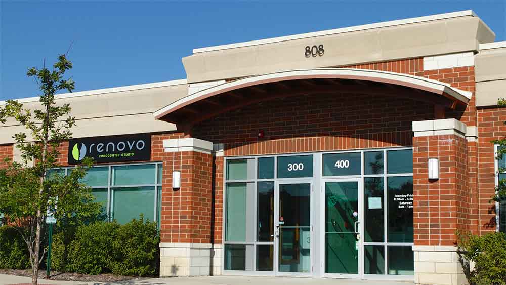 xterior of Renovo Endodontic Studio with glass doors and brick facade.