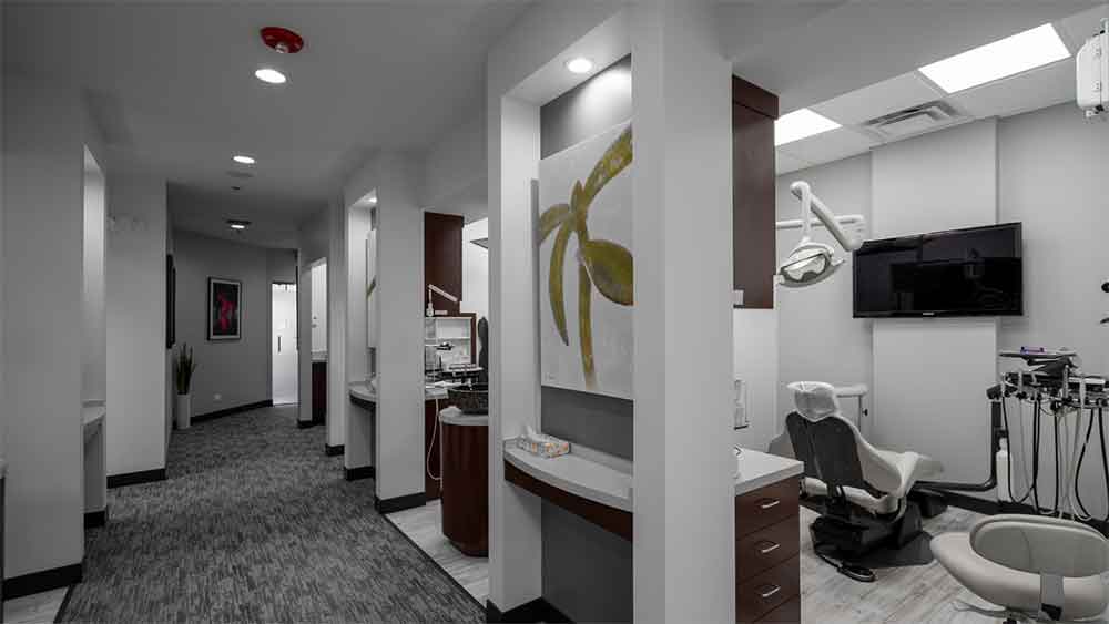 Modern dental office with treatment rooms and hallway.