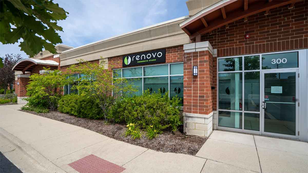 A modern orthodontic studio with a brick exterior and glass entrance.