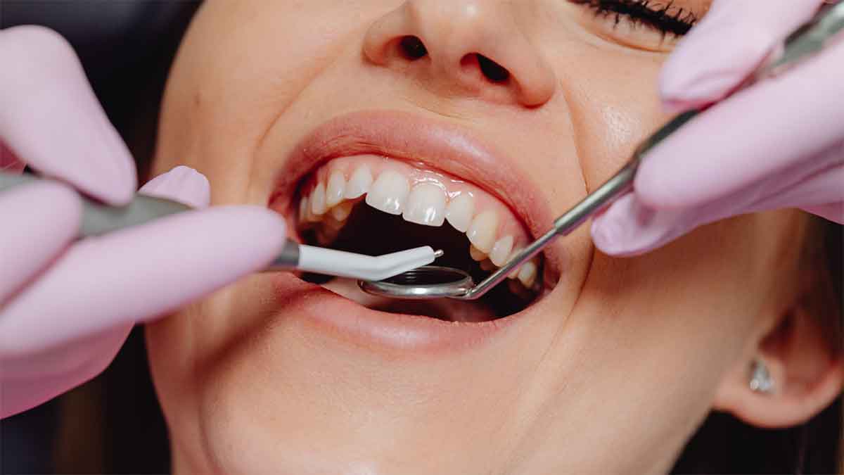  Close-up of a woman getting a dental checkup.