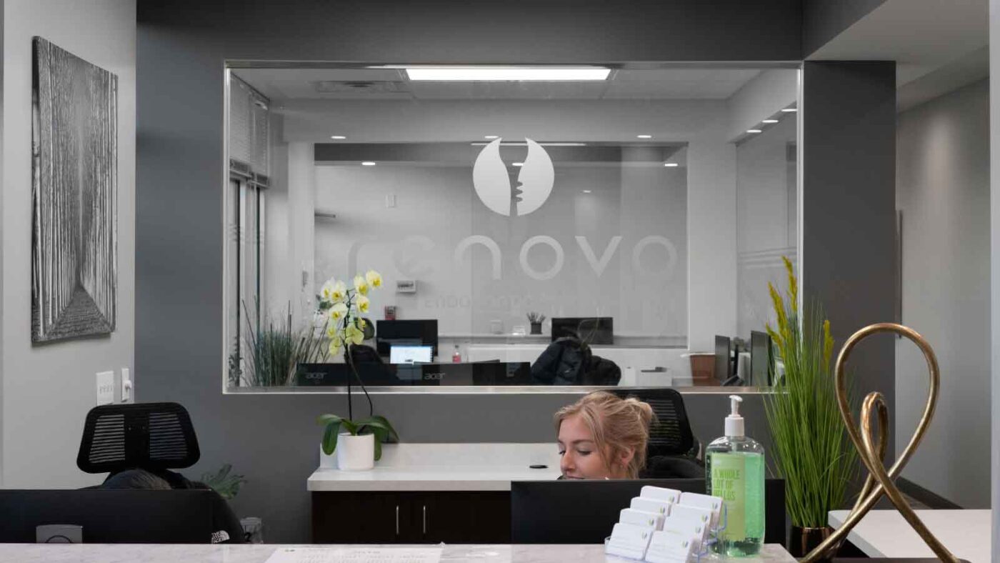 Reception area of a modern dental office with staff at desk.