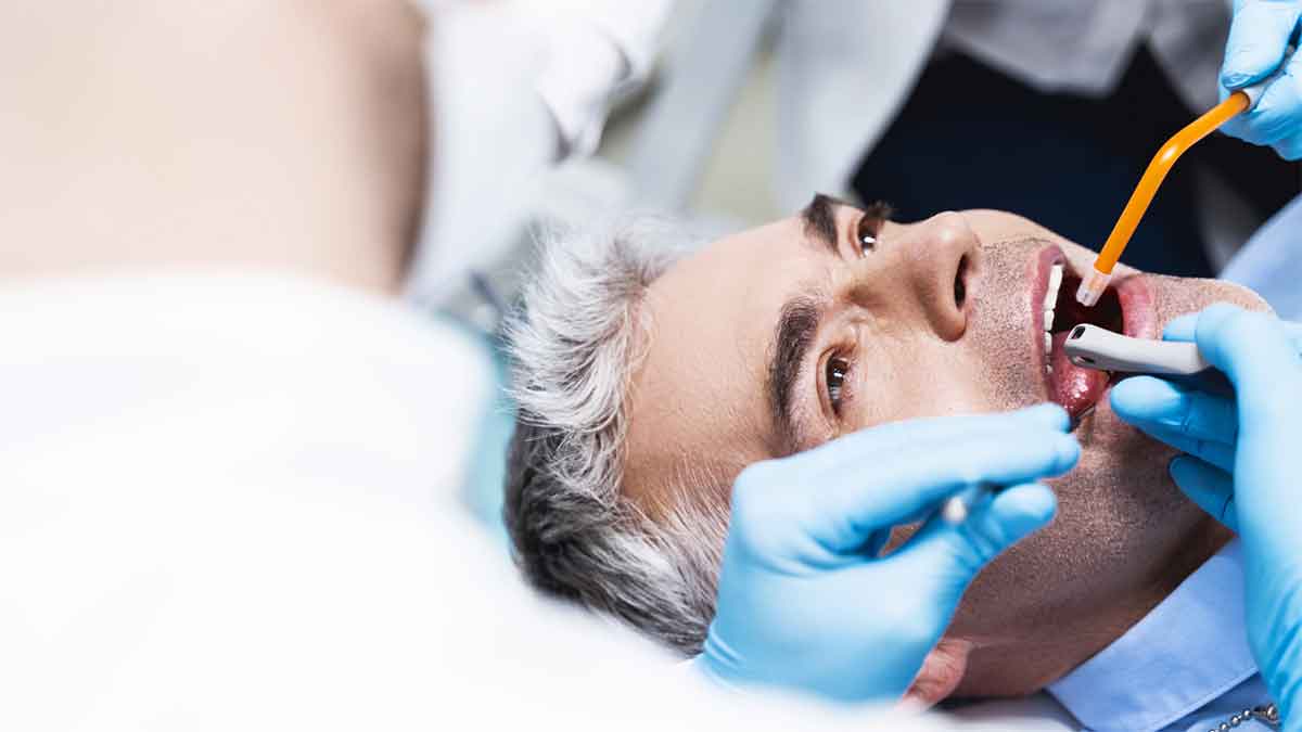 Man-receiving-dental-treatment-from-a-professional-in-a-clinic