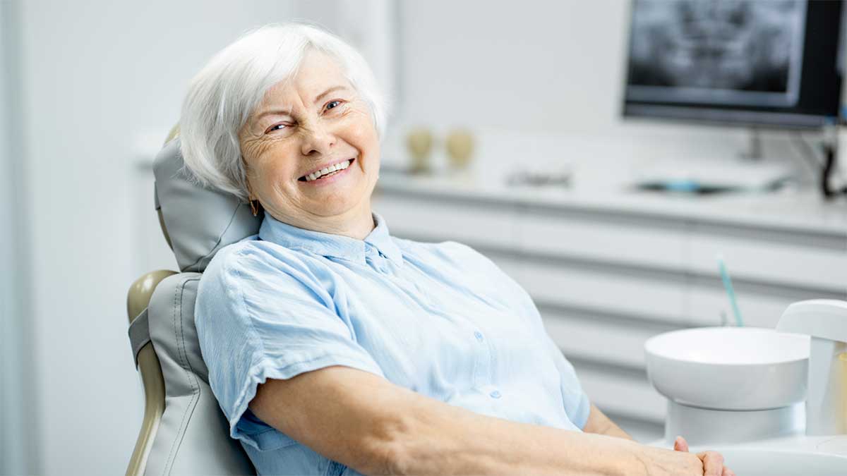A-smiling-senior-woman-in-a-dental-chair-during-a-check-up