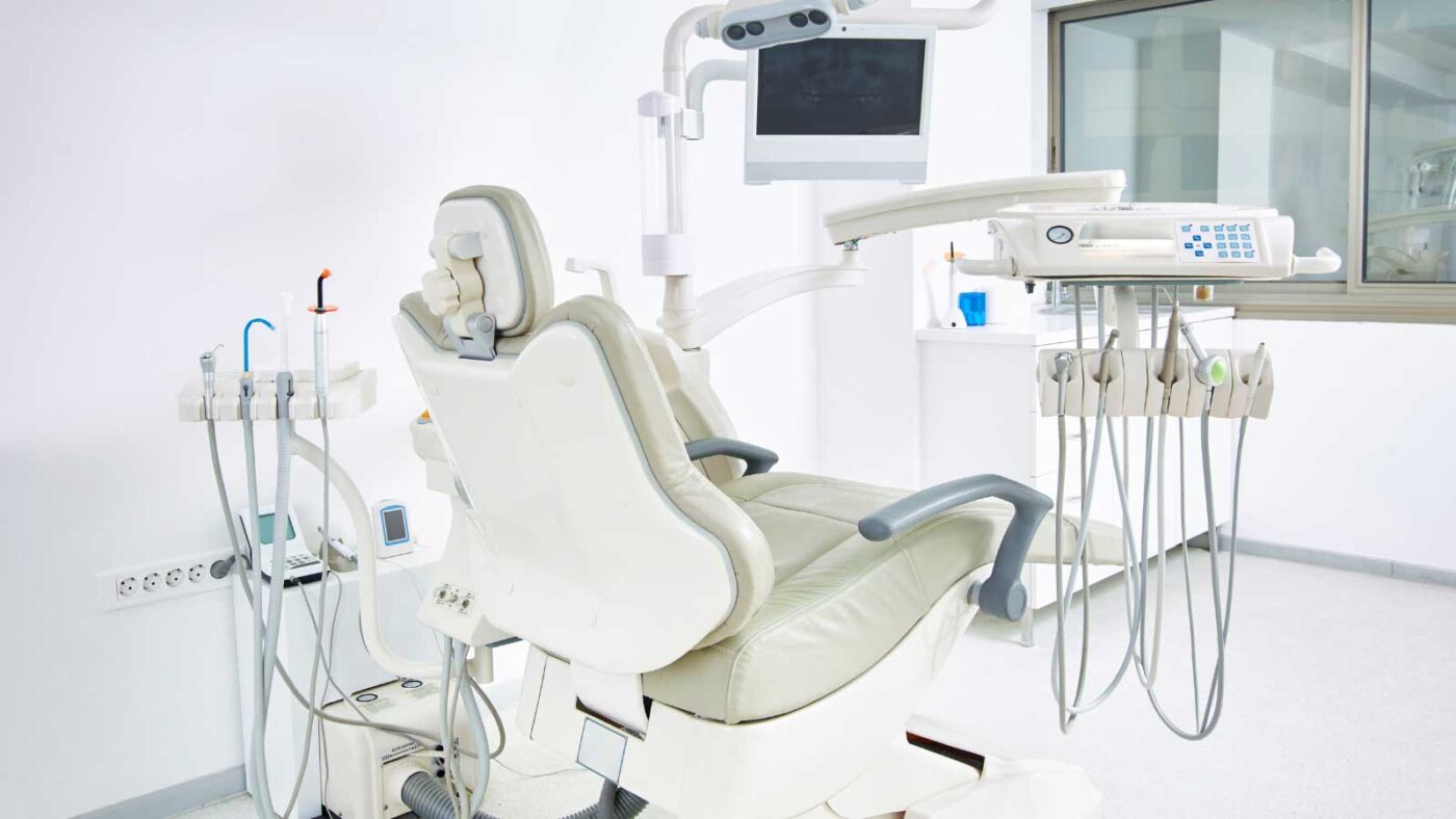 Empty dental chair with attached equipment in a clean clinic