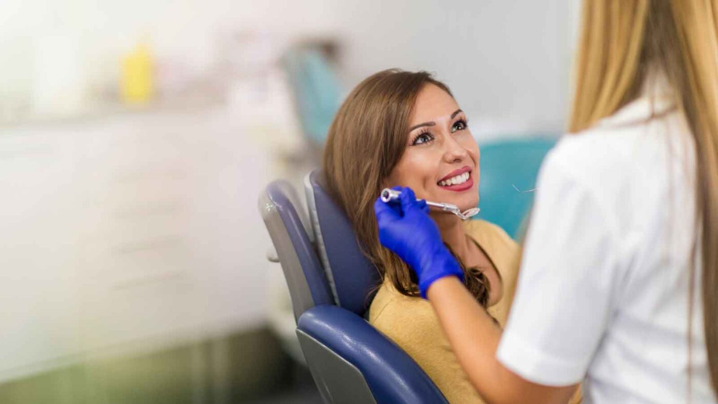 Woman smiling during dental checkup.