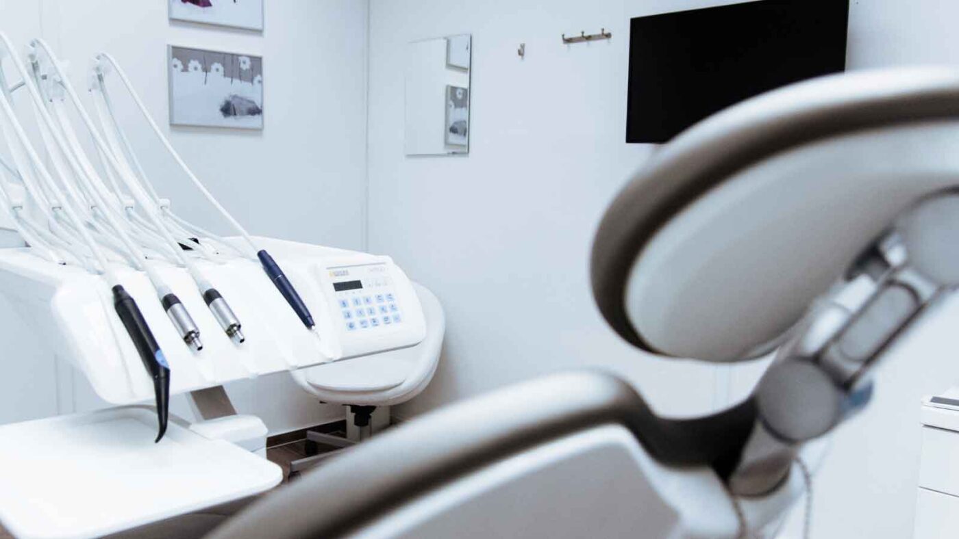 Close-up of dental tools and chair in a clinic