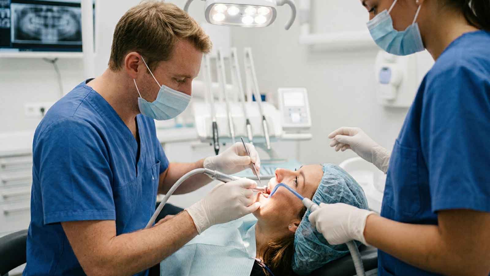 Patient receiving specialized dental treatment from an endodontic team.